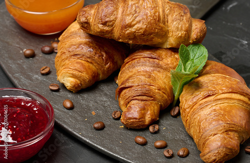Baked croissant on black board, delicious breakfast,