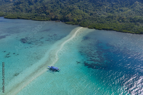 A sinuous sand bank stretches out from Snake Island in Bacuit Bay near El Nido, Philippines. This idyllic spot is a popular tourist destination and is a wonderful place to swim.