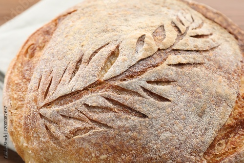 Bild auf Leinwand Loaf of freshly baked bread on table, above view