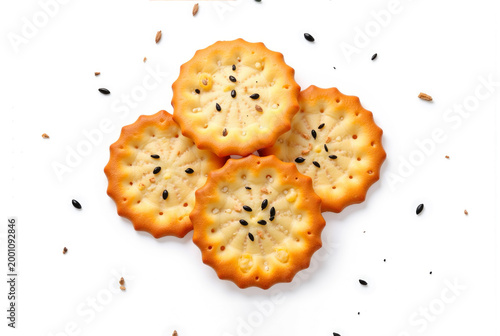 Four appetizing sesame cookies isolated on a white background, golden baked treats with a crisp texture, simple and clean food composition.