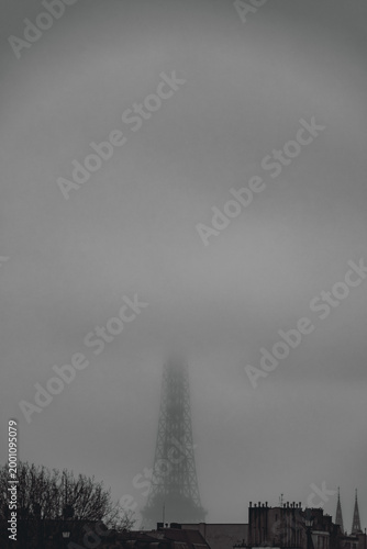 Eiffel tower emerging from fog