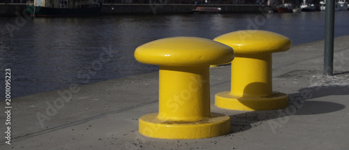 Schilderij op canvas Yellow Mooring Bollards on Waterfront at Hammarby Canal in Stockholm Sweden