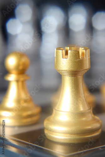 Macro phot golden chess pieces on the board concept strategy business vertical orientation