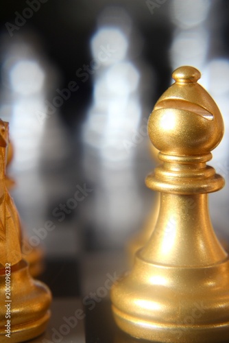 Macro phot golden chess pieces on the board concept strategy business vertical orientation