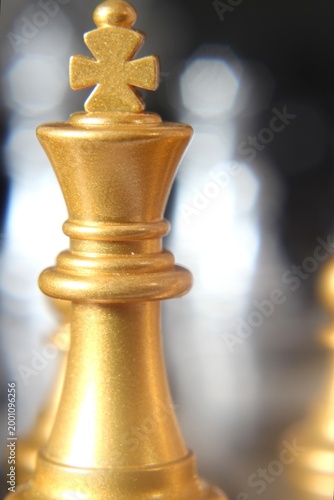 Macro phot golden chess pieces on the board concept strategy business vertical orientation