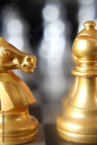 Macro phot golden chess pieces on the board concept strategy business vertical orientation