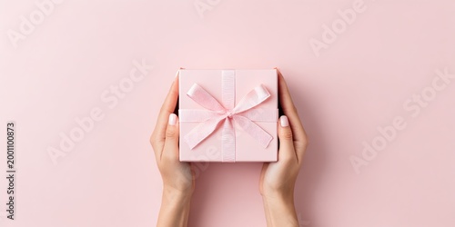 Holding a pink gift box in two hands