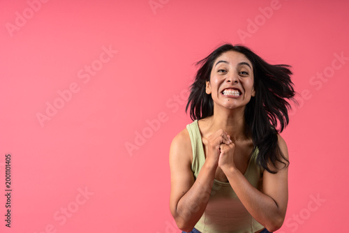 Obraz na plátně Excited woman celebrating victory with clenched fists