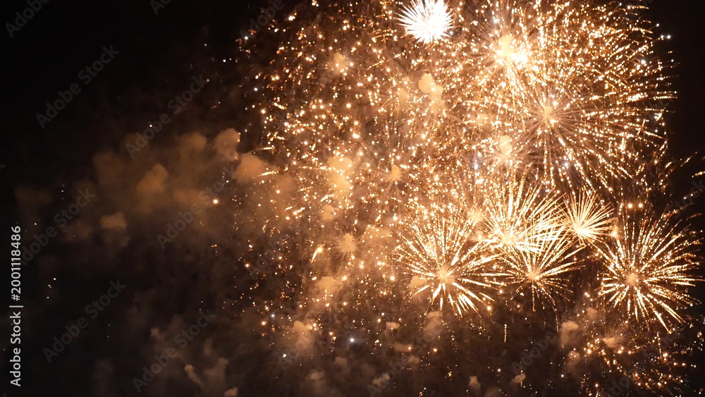 Fototapeta premium Golden Firework celebrate anniversary happy new year 2023, 4th of july holiday festival. Gold firework in the night time celebrate national holiday. Countdown to new year 2023 gold party time event