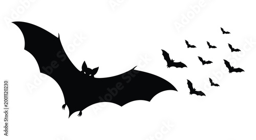 A swarm of bats in flight silhouette halloween night and spooky wildlife scene