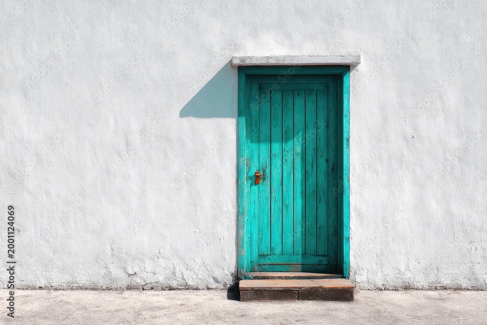 Fototapeta premium Rustic teal door set in a stark white textured wall with a concrete base