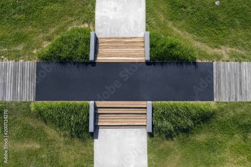 Overhead view of modern park seating and pathways with grass and wood elements