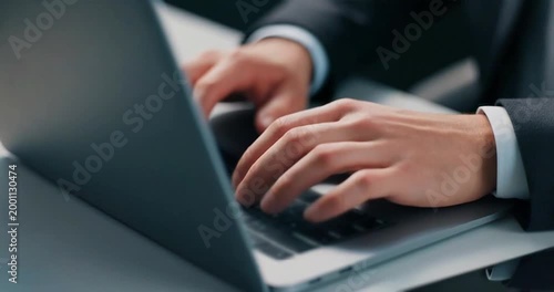 Close up of man hands typing on laptop keyboard in office working video footage.
