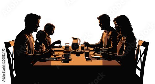 Family sitting at dinner table eating.
