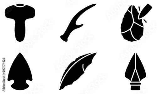 collection of six black silhouettes of prehistoric stone tools and weapons on white background