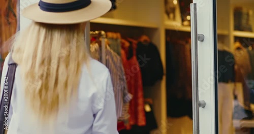 Woman Entering Clothing Store with Glass Door