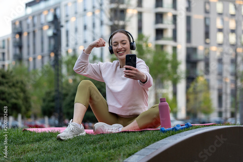Photography Woman celebrating fitness progress connecting online