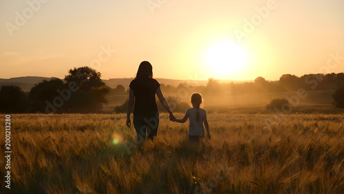 Serene Sunset Walk with a Child in Golden Fields