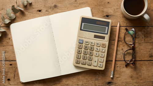 Elegant workspace setup with classic calculator, notebook, and coffee essentials