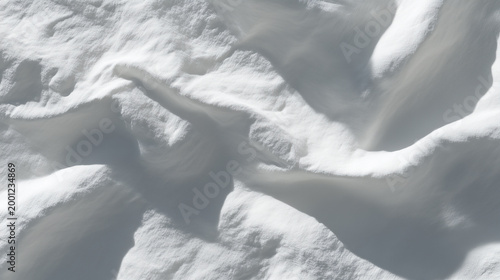 Top view of clean white snow texture with soft drifts and shadows