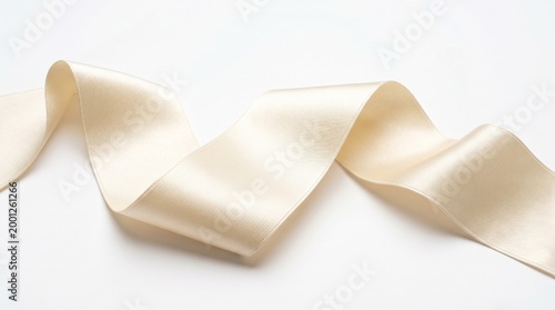 A roll of cream-colored satin ribbon on a white background