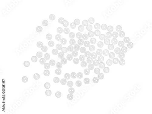 Fotografía Top-view of many small white plastic buttons scattered on Transparent background, minimal studio flat lay with copy space