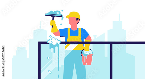 Professional window washer cleaning high rise glass with squeegee and bucket
