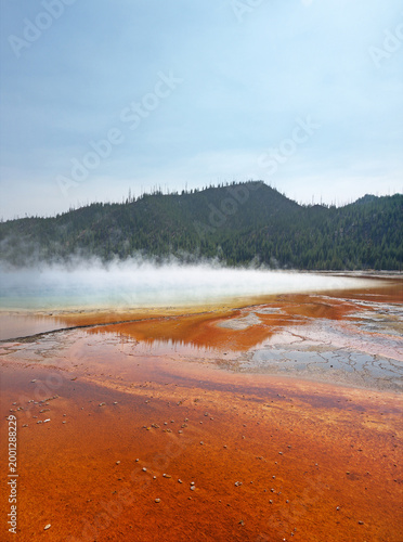 Grand Prismatic Spring orange volcanic surface, with stream rising from hot thermal water in Yellowstone National Park