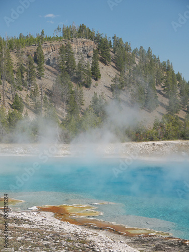Excelsior Geyser pool with Steam rises from turquoise hot spring water  in Yellowstone National park