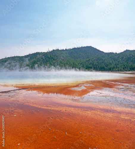 Grand Prismatic Spring orange volcanic surface, with stream rising from hot thermal water in Yellowstone National Park