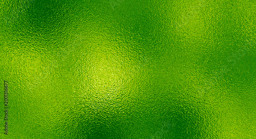 Bright green metallic foil texture with a shimmering crumpled surface and reflective light highlights.
