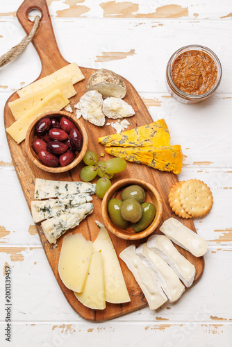 Fotografija Cheese board with assorted cheeses and olives