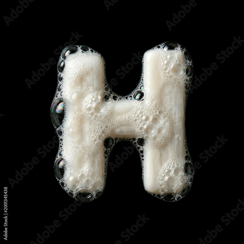 Solid soap with bubbles and foam letter H - large creative font isolated on black background. Perfect alphabet for creative illustrations related to beauty, hygiene, purity...