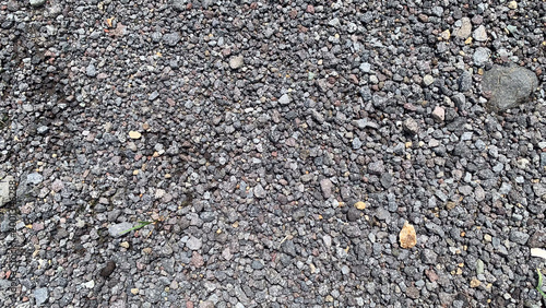 Tableau sur toile ​Top view of grey volcanic gravel texture background with small crushed stones and pebbles on the ground
