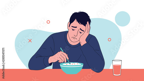 Sad and lonely man sitting at a table and slowly eating a bowl of cereal while feeling depressed or bored in the morning.
