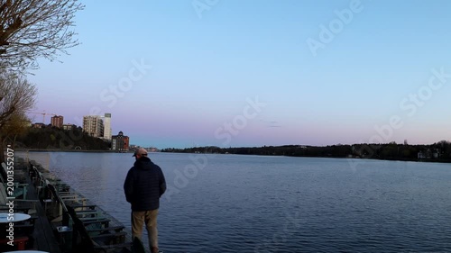 Stockholm, Sweden A man walks at dawn by the Baltic Sea seaside in the Nacka Strand district.  