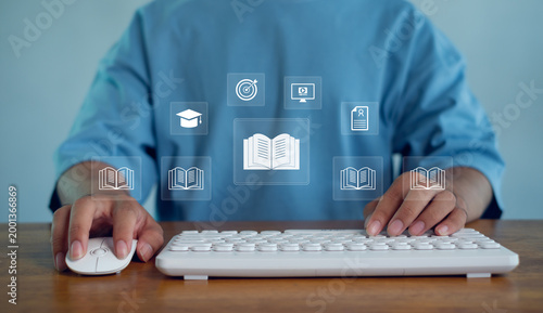 Foto Online learning concept with person using computer keyboard and digital book icons, representing e-learning, education technology, knowledge access, remote study, and modern training solutions