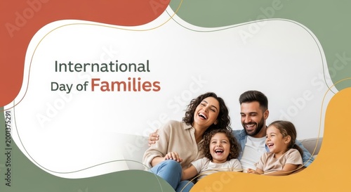 A happy multi-ethnic family with two daughters sitting on a couch and laughing, with abstract shapes and text International Day of Families in the background.