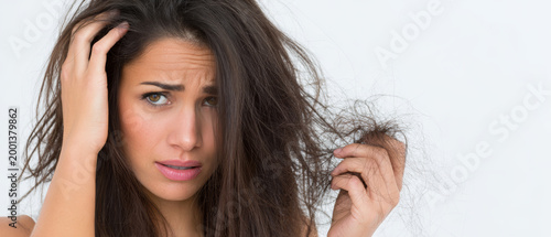 Worried woman damaged hair breakage dry hair split end female beauty problem