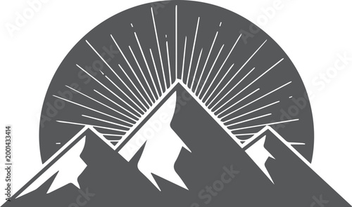 Dark mountain peaks with sunburst rays