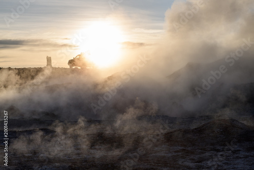 Dramatic sol de manana geothermal field with steam and sunrise