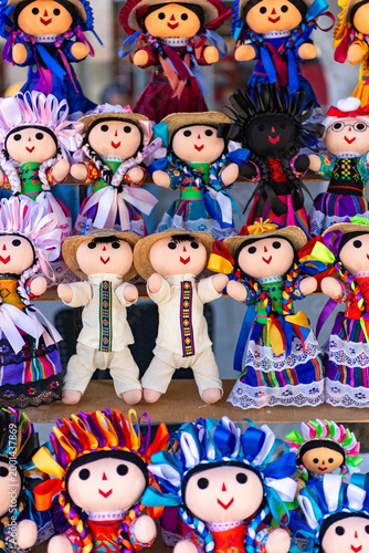 Bild auf Leinwand Colorful Textile Lele Dolls Displayed for Cultural Sale in a Market Setting