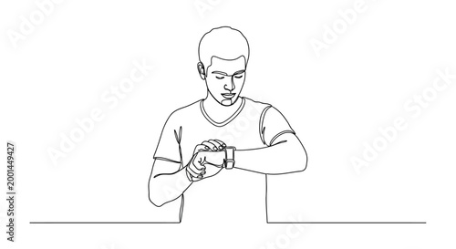 Man looking at watch while standing at table with concern