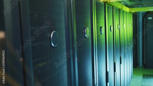 Camera sliding right revealing server racks, golden nodes appearing and brightening to show network