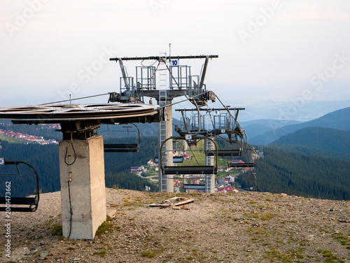 Canvas Print A chairlift sits ready for riders, offering a beautiful view of green hills and scenic valleys in the distance