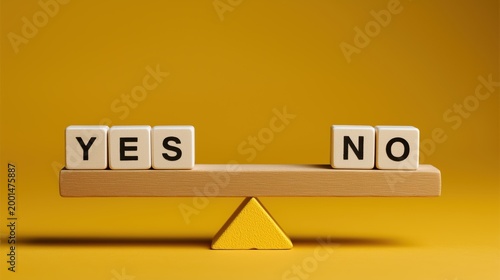Wooden blocks with Yes and No words balancing on a seesaw scale. Business choice, decision making and dilemma concept on yellow background