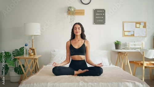 Young Hispanic sportswoman doing yoga pilates workout at cozy home. 