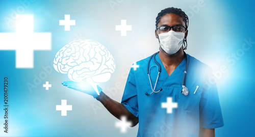 Tableau sur toile Medical professional holds brain icon while wearing mask and scrubs in a healthc