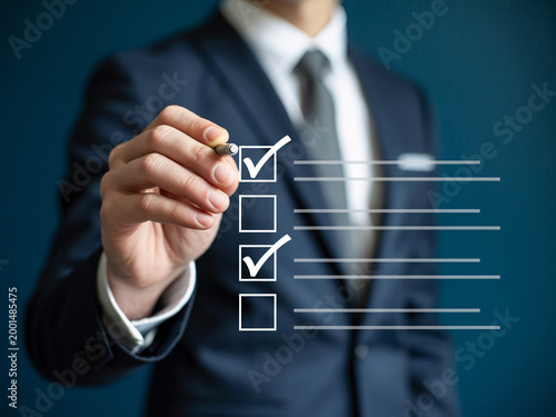 A businessman in a suit checks boxes on a transparent checklist