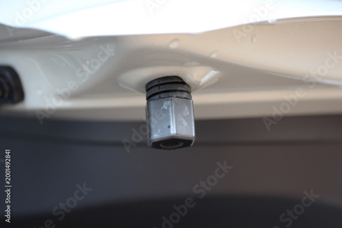 Macro of an adjustable bump stop on a new vehicle trunk lid